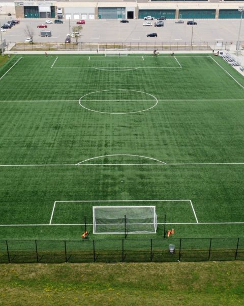 An aerial shot of a green soccer field.
